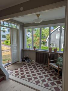 a living room with a checkered floor and windows at 30-tals villa med närhet till centrala GBG in Gothenburg