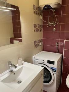 a bathroom with a washing machine and a sink at Apartman Višić 1692 in Kaštela +30 photos