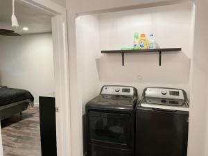a small kitchen with a stove and a shelf at Charming 2-Bed Apartment in Houston in Houston