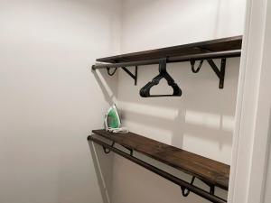 a wooden shelf on a wall with a shelf at Charming 2-Bed Apartment in Houston in Houston