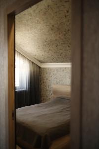 a small bedroom with a bed and a window at Sweet Home in Yengidzha +16 photos