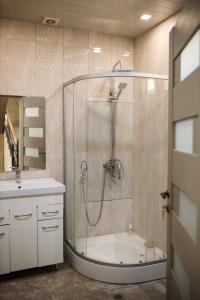 a bathroom with a shower with a tub and a sink at Sweet Home in Yengidzha