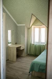 1 dormitorio con 1 cama, escritorio y ventanas en Sweet Home en Yengidzha