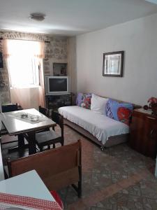 a living room with a couch and a tv at Apartment Radovic in Kotor
