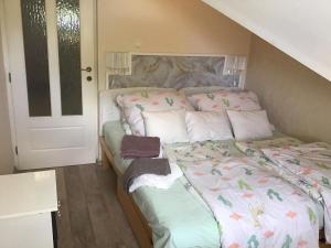 A bed or beds in a room at Family Wellness Apartman