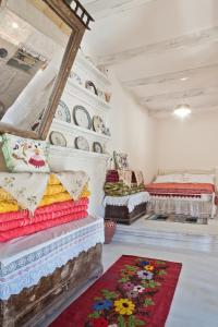 a living room with two beds and a rug at Traditional Karpathian house in Karpathos Town