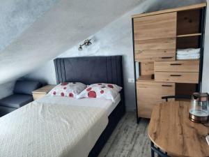 a bedroom with a bed and a wooden table at Apartments Peričić in Podstrana