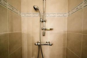 a shower with a hose in a bathroom at Le Pech Merle YourHostHelper in Saint-Jean-de-Minervois +30 photos