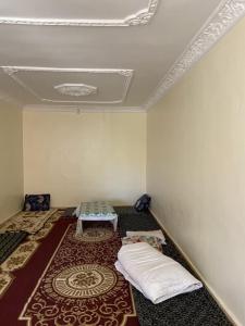 a room with two beds and a rug on the floor at GuestHouse Gafait in Guefaït