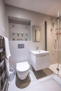 a white bathroom with a toilet and a sink at Beautiful & Spacious Retreat in Winchester in Winchester