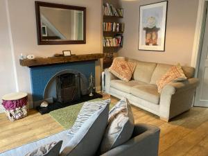 a living room with two couches and a fireplace at Spacious cottage, central Ballycastle. in Ballycastle