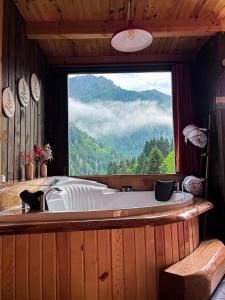 a bath tub with a view of a mountain at Kukudi House in Ayder Yaylasi