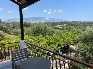 a balcony with a table and a view of mountains at Andreas Studios in Svoronata