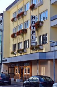 a hotel with flowers on the front of it at Hotel Garni Oberrhein in Rheinfelden