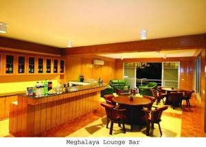 a kitchen with tables and chairs and a bar at Nazimgarh Garden Resort in Sylhet +10 photos