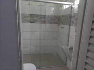 a bathroom with a shower with a toilet and a sink at Recanto Sossego in Pirenópolis