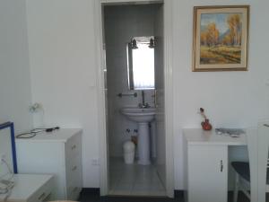 a white bathroom with a sink and a mirror at Hotel Vila Bojana in Bled