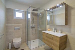 a bathroom with a shower and a toilet and a sink at FRANKO in Senj +20 photos