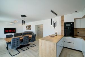 a kitchen and dining room with a table and chairs at FRANKO in Senj