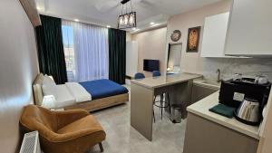 a hotel room with a bed and a kitchen at MD Apart Hotel Tbilisi in Tbilisi City