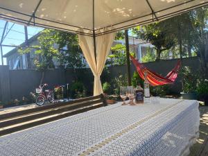 a white table with two wine glasses and a tent at Hotel Liza in Batumi