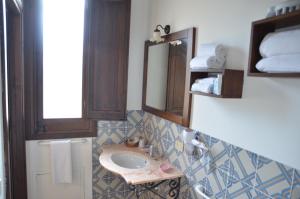 a bathroom with a sink and a mirror at GIARDINO del MARE in Petrosino +142 photos