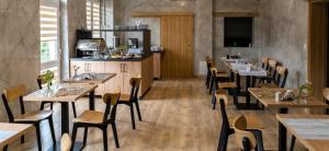 a restaurant with tables and chairs in a room at Lynks Resort in Ustrzyki Dolne