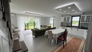 a kitchen and living room with a table and chairs at Greenplain Smurf in Trabzon