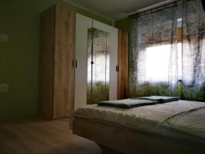 a bedroom with a bed next to a window at Apartments Anita in Crikvenica