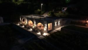an aerial view of a house at night with lights at Apartments and Winery Djukovic in Virpazar