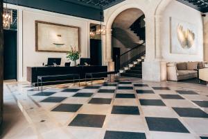 a lobby with a checkered floor and a staircase at Sant Francesc Hotel Singular in Palma de Mallorca