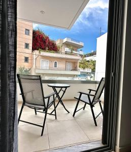 a patio with two chairs and a table on a balcony at Dafni City Apartment 3 in Athens