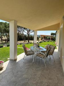 a patio with a table and chairs on it at Appartamento i Pini in Palau +35 photos