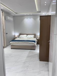 a bedroom with a bed in a white room at جناح فندقي في فله خاصة in Abha