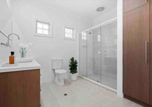 uma casa de banho com um chuveiro, um WC e um lavatório. em Executive living in City fringe location em Glenunga