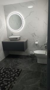 a bathroom with a sink and a mirror and a toilet at Tiernan's Luxury King Room Ensuite in Charlestown