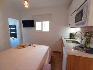 a small kitchen with a bed and a sink at Marixa Room in Nerja