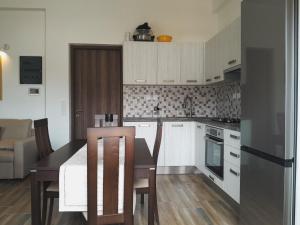 a kitchen with white cabinets and a table and chairs at Preet House in Víssa
