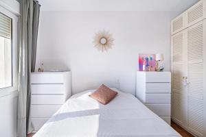 a white bedroom with a bed with a pillow on it at Espectacular Dubamar 606 in Aguadulce