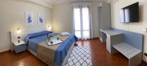 a hotel room with a bed with a tray on it at Scala dei Turchi Palace Suites in Realmonte