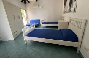 a bedroom with two bunk beds and a hallway at Meravigliosa casa con vista Tropea in Santa Domenica