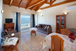 a large living room with a view of the ocean at Villa Avgerini Paxos in Gaios