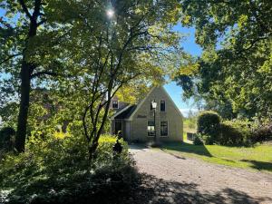 a small house in the middle of a dirt road at Spacious Country Retreat in Den Burg