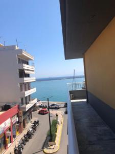a view of the ocean from a balcony of a building at vintage apartment with port view in Chios