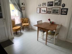 una sala da pranzo con tavolo e sedie in legno di Pensionat Gyllenhjelmsgatan a Strängnäs