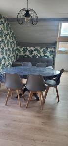 a dining room with a blue table and chairs at La Plante, tendance et design in Ornans +7 photos