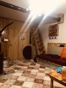 a room with a attic with a staircase and a table at Trabzon Uzungöl dağ evi in Trabzon