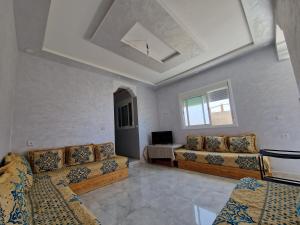 a living room with two couches and a table at Dar Sevilla in Asilah
