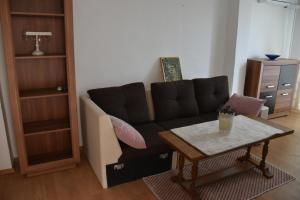 a living room with a couch and a coffee table at Apartment Monika in Široki Brijeg