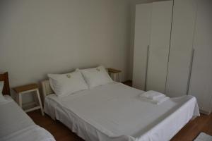 a bedroom with two beds with white sheets and pillows at Apartment Monika in Široki Brijeg